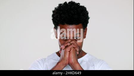 African man feeling hopeful with sign of prayer and faith portrait smiling and charismatic being grateful Stock Photo