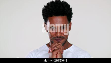 African man feeling hopeful with sign of prayer and faith portrait smiling and charismatic being grateful Stock Photo