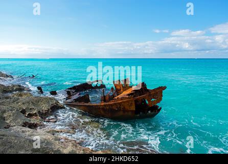 The deteriorating Gallant Lady shipwreck on the rocky coastline of North Bimini, Bahamas, in the blue Atlantic ocean. Stock Photo