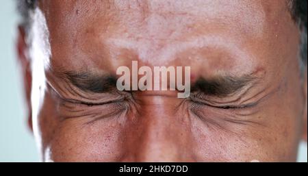 Person close-up eyes closed feeling upset feeling emocional, squinting eyesight Stock Photo