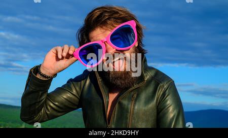 Bearded man in big glasses outdoors. Hipster with beard and mustache in funny big eyeglasses Stock Photo