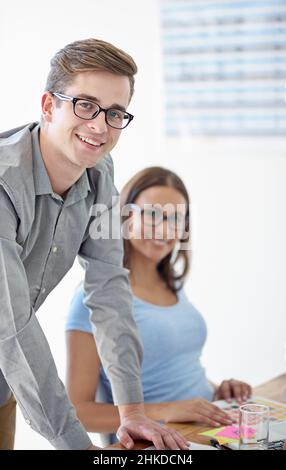 Collaborating on a design project. Portrait of two young designers in their office. Stock Photo