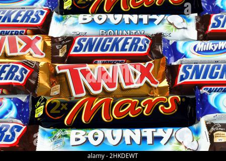 Kiev, Ukraine - December 13, 2021: Background of Mars, Bounty, Twix, Snickers and Milky Way chocolate bars. Mars is a company known for the confection Stock Photo