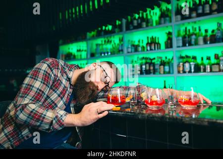 Drunk bearded man fell asleep at the bar Stock Photo