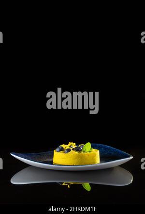 Yellow light dessert on a black background with reflection Stock Photo