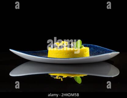 Yellow light dessert on a black background with reflection Stock Photo