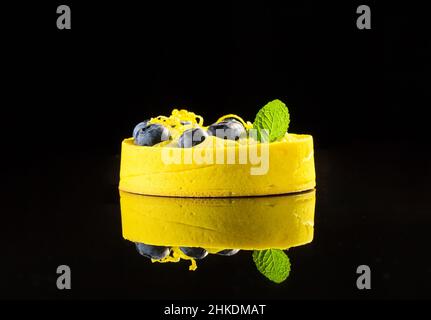 Yellow light dessert on a black background with reflection Stock Photo