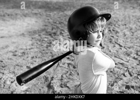 Child baseball player focused ready to bat. Kid holding a baseball bat. Stock Photo