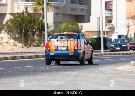 Hurghada, Egypt - January 30, 2022: Taxi cab drives on a street in Hurghada, Egypt. Stock Photo