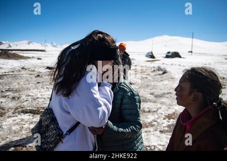 (220204) -- LHASA, Feb. 4, 2022 (Xinhua) -- Tenzin Drolma (L) greets her grandmother in Gyaga Village of Damxung County, southwest China's Tibet Autonomous Region, Jan. 18, 2022. Tenzin Drolma, 21, was born on the grassland near Lake Namtso in Tibet. In 2020, she was admitted to Jiangsu Food and Pharmaceutical Science College in east China's Jiangsu Province as a Chinese pharmacy major student. The college life in the outside world is fresh to Drolma. She met many new classmates and made many friends. When winter vacation came, Drolma returned to her beloved home. 'I leave my hometown in Stock Photo