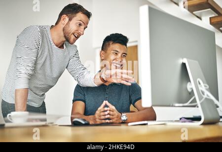 Using computer software to execute designs. Cropped shot of two designers working together on a project in an office. Stock Photo