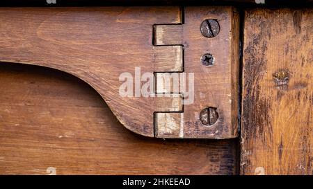 close-up of ancient wooden table hinge with rusty screws, panorama Stock Photo