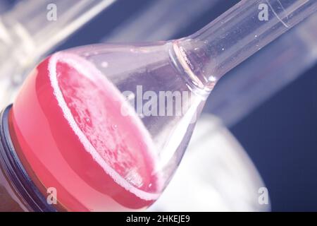 Laboratory glassware with pink fluid. Stock Photo