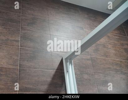 Cracked tile wall in the bathroom. Building problems and solutions concept. Stock Photo