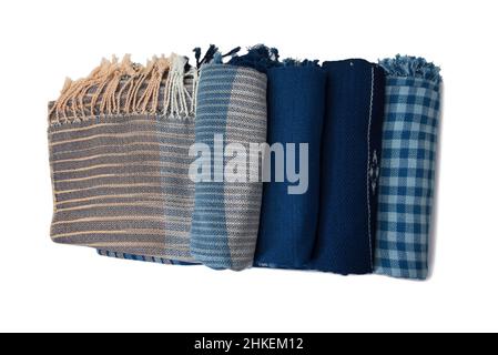 Roll of hand woven shawls, Thai cotton indigo dyed isolated on white background Stock Photo