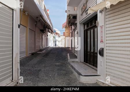 Santorini,  Greece - May 5, 2021 : An  empty alley with closed shops in the center of Fira Santorini Stock Photo