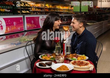 EDITORIAL USE ONLY (Left to right) Shelly and Oliver Ward try the foods available in the new Mood Food aisle at Iceland, which has been launched ahead of Valentine's Day and features the top ten foods that have been voted by British people as the most likely to get them in the mood for love, which include ice cream, pizza and roast dinner, Deeside. Issue date: Friday February 4, 2022. Stock Photo