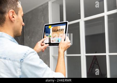 Male hands with tablet, closeup. World map with delivery network on screen. Logistics concept. Stock Photo