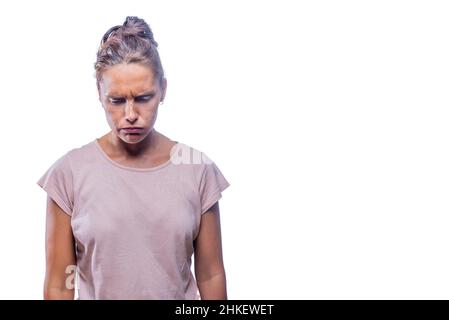 A concerned adult woman standing looking down Stock Photo