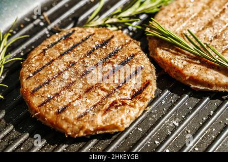 Veggie cutlet is grilled for veg burger. Vegetarian products from plant-based meat concept, beyond kitchen background. High quality photo