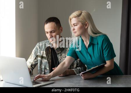 cropped view of soldier in camouflage uniform using laptop Stock Photo