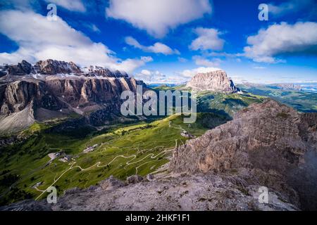 Aerial view on Gardena Pass, rock faces of Sella group and Piz Boe left, Saslonch, Sassolungo or Langkofel at right, seen from the summit of Grand Cir Stock Photo