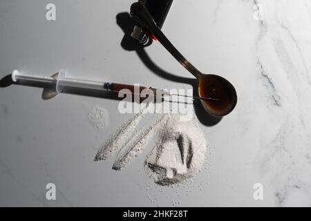 Drugs of various kinds and human skulls on the floor, Collection of different hard drugs Heroin Stock Photo