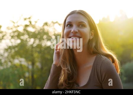 Early morning girl enjoying the first rays of sunshine of the day in nature Stock Photo