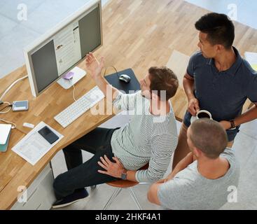 Taking care of business. High angle shot of three designers working together on a project in an office. Stock Photo