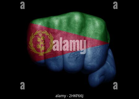 Flag of Eritrea painted on strong fist on black background Stock Photo