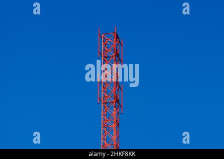 red-painted top of the tower intended for the installation of modern equipment for the purpose of data transmission, selective focus Stock Photo