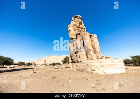 Luxor, Egypt - January 26, 2022: The Colossi of Memnon in Luxor, Egypt. Two massive stone statues of the Pharaoh Amenhotep III Stock Photo