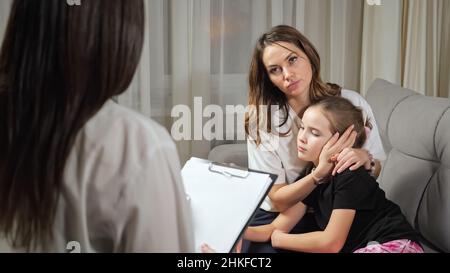 Mother listens to doctor prescribing medication for daughter Stock Photo
