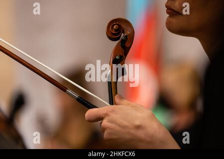 Symphony orchestra on stage, hands playing violin Stock Photo