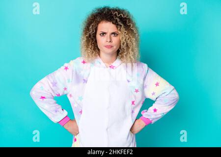 Photo of angry young wavy hairdo lady fists waist wear kigurumi isolated on blue background Stock Photo