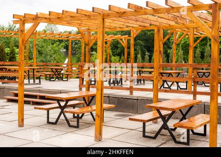 Covered seating area. Gazebo, pergola in parks and gardens - relax and unwind. Wooden gazebo in the Park. Stock Photo
