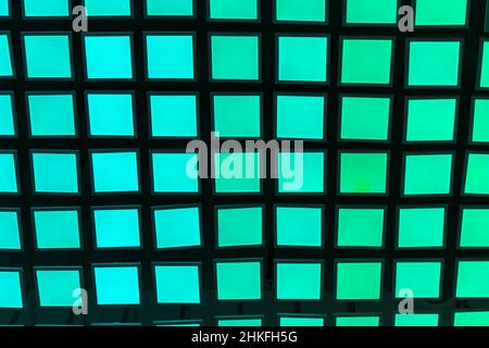 Neon vibrant green and aquamarine square tiles modern background. Stock Photo