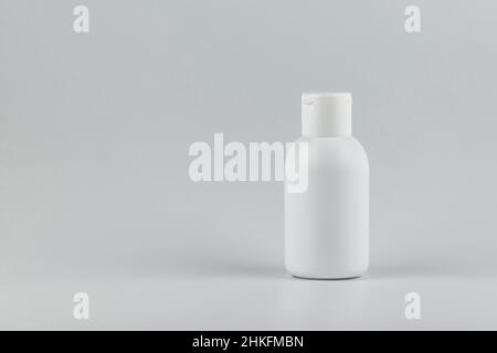 Unbranded white plastic flacon for cosmetics products.  Skincare and cosmetology mockup with copy space. Branding identity template for text and desig Stock Photo