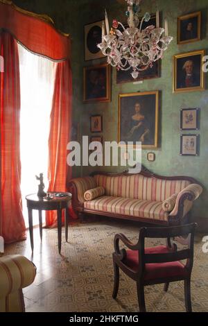 Malta, Valletta, green room decorated with period furniture and portraits within the Casa Rocca Piccola, a 16th century palace which houses a private museum and a bed and breakfast Stock Photo