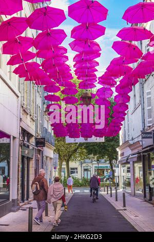 France, Dordogne, Perigueux, stage town on the Via Lemovicensis or Vezelay Way, one of the main ways to Santiago de Compostela, Chaines street adorned with pink umbrellas for the launch of Pink October, a cancer screening campaign Stock Photo