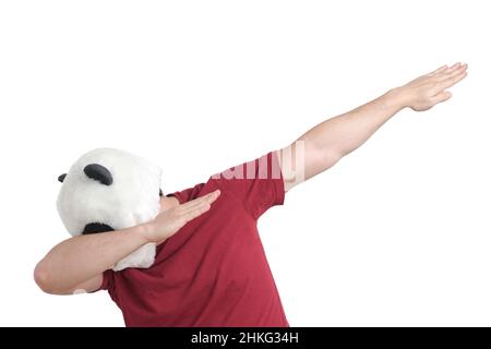Man wearing a panda mask head throwing dab move, isolated. Stock Photo