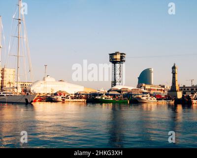Port in Barcelona with Cable Car tower (central) and clock tower / Torre del Rellotge Barceloneta (right). Barcelona, Catalonia, Spain Stock Photo
