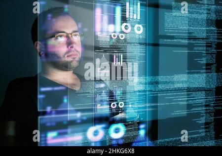 Looking over the data. Cropped shot of a young computer programmer looking through data. Stock Photo