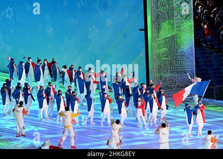 Beijing, China. 04th Feb, 2022. Olympics: Opening ceremony in the Olympic stadium 'Bird's Nest'. The team from France with flag bearer Tessa Worley and Kevin Rolland runs into the stadium. Credit: Peter Kneffel/dpa/Alamy Live News Stock Photo