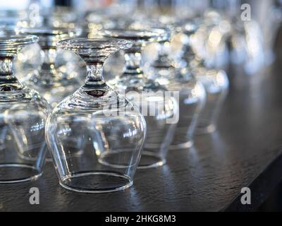 Rows of empty wine glasses on the showcase Stock Photo