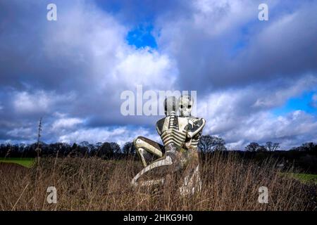 'The Nuba Survival' is a five-metre-tall statue of two skeletons locked in an embrace in Checkendon, Oxfordshire. The statue was created by local artist John Buckley - best known for his sculpture of a shark sticking out of a roof in Headington - in 2001 after he visited the Nuba peoples in Sudan. Picture date: Friday February 4, 2022. Photo credit should read: Steve Parsons/PA Wire Stock Photo