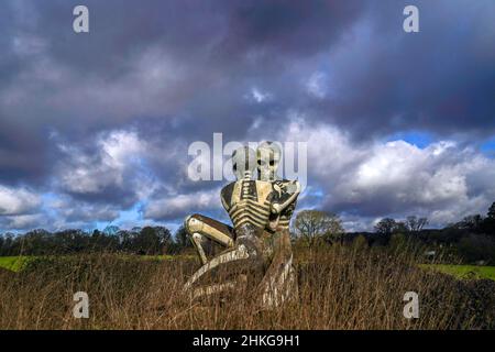 'The Nuba Survival' is a five-metre-tall statue of two skeletons locked in an embrace in Checkendon, Oxfordshire. The statue was created by local artist John Buckley - best known for his sculpture of a shark sticking out of a roof in Headington - in 2001 after he visited the Nuba peoples in Sudan. Picture date: Friday February 4, 2022. Photo credit should read: Steve Parsons/PA Wire Stock Photo