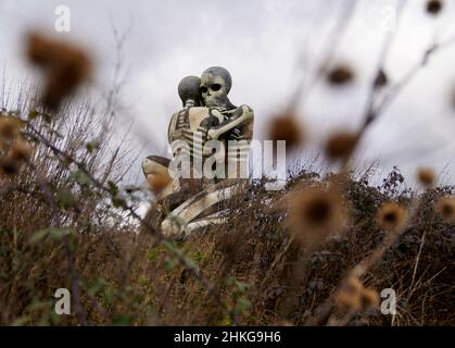 'The Nuba Survival' is a five-metre-tall statue of two skeletons locked in an embrace in Checkendon, Oxfordshire. The statue was created by local artist John Buckley - best known for his sculpture of a shark sticking out of a roof in Headington - in 2001 after he visited the Nuba peoples in Sudan. Picture date: Friday February 4, 2022. Photo credit should read: Steve Parsons/PA Wire Stock Photo