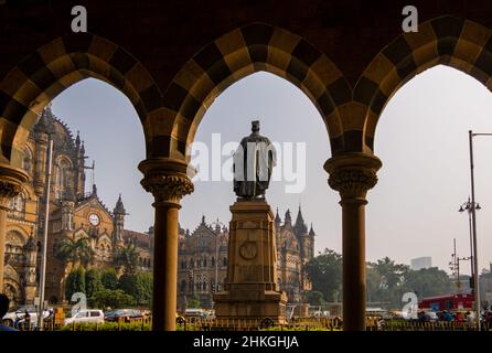 MUMBAI, INDIA - December 18, 2021 : Statue of Pherozeshah Mehta known as The Lion of Bombay with CST station,UNESCO World Heritage Site in Mumbai Stock Photo