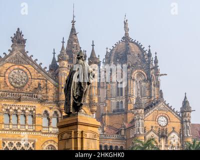 MUMBAI, INDIA - December 18, 2021 : Statue of Pherozeshah Mehta known as The Lion of Bombay with CST station,UNESCO World Heritage Site in Mumbai Stock Photo